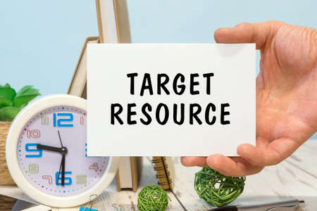 Target Resource - text on a card in your hand next to office suppliesの写真素材