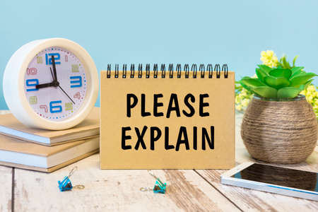 A sign with the inscription PLEASE EXPLAIN on the table with office supplies
