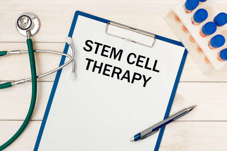 Paper with STEM CELL THERAPY on the office desk, stethoscope and penの写真素材
