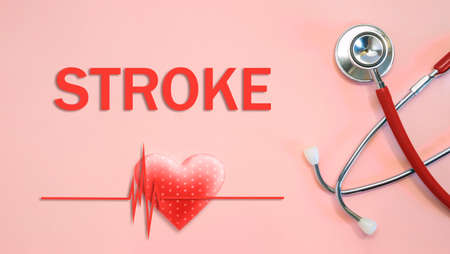 STROKE concept with stethoscope and heart shape on a red backgroundの写真素材