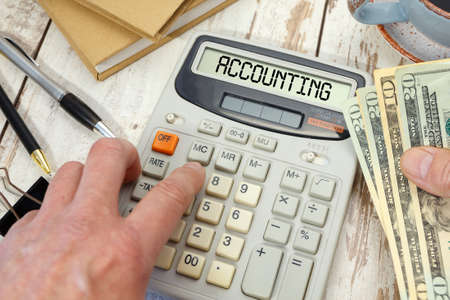 ACCOUNTING - word on calculator. Business and tax concept.の写真素材