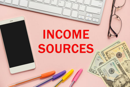 The inscription - Income Sources, near office supplies, keyboard, phone and money.の写真素材