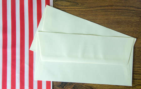 Two blank envelopes on wood table.