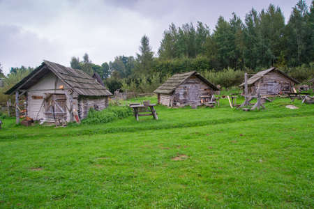 Medieval houses made from wood in nature. Green vegetation around.の写真素材
