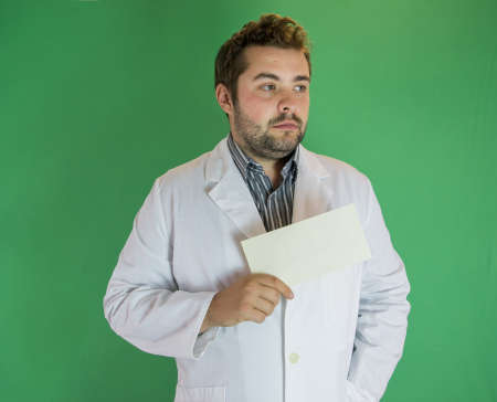 Young male doctor holding blank envelope. Copy space available.