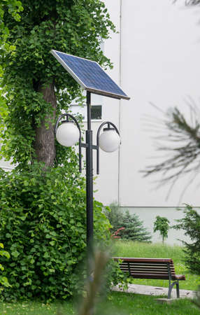 Street lights using solar panel energy generator in a public park.の写真素材