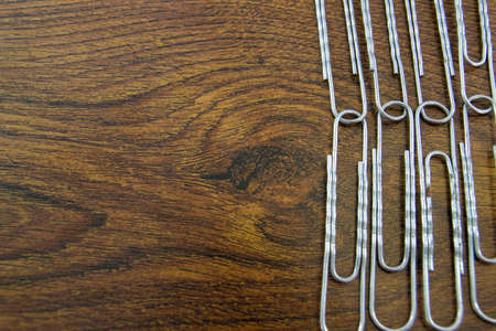 Paperclips on wood texture desk.の写真素材