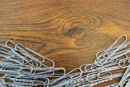 Paper clips on wood texture table.の写真素材