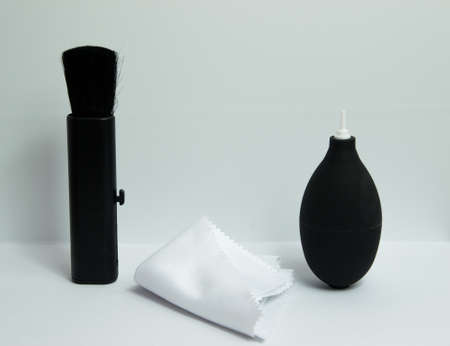 Lens cleaning kit with brush, fibre napkin and air blowing pump on white background.の写真素材
