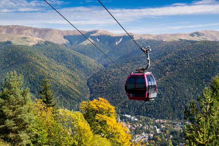 Cableway going downhill with mountain landscape in the background.の写真素材