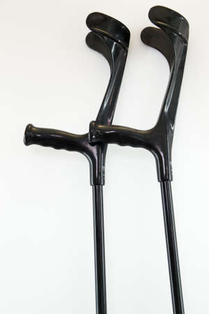 Pair of black crutches in white background.の写真素材