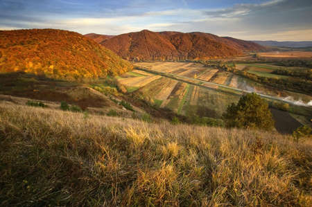 view of a valley over hills in autumn の写真素材