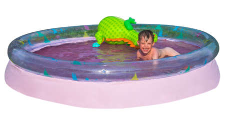 a small child bathes in inflatable pool isolated on whiteの写真素材