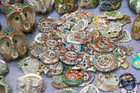 Many clay figurines of various shapes and different colors lying on the table. There are abstract shapes.の写真素材