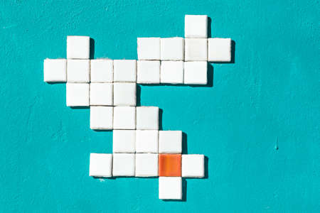 On the painted wall pattern of small tiles. Wall painted in celadon. The tiles are white and one...