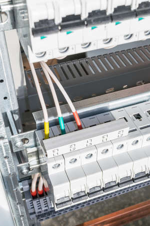 Connecting cables with cable lugs to circuit breakers in the electrical control panel on the...