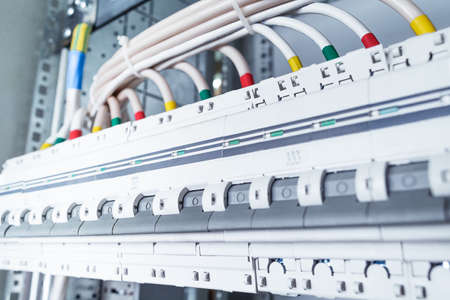 Connecting cables with cable lugs to circuit breakers in the electrical control panel on the...
