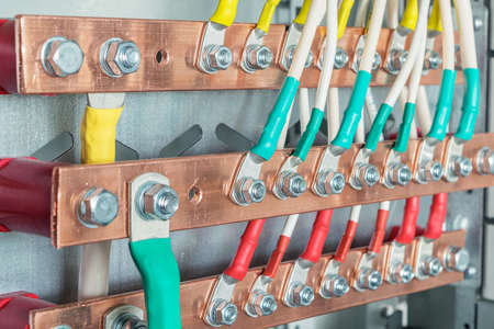 Connecting the wires with the bolts and nuts to the copper rails in the electrical Cabinet. A...