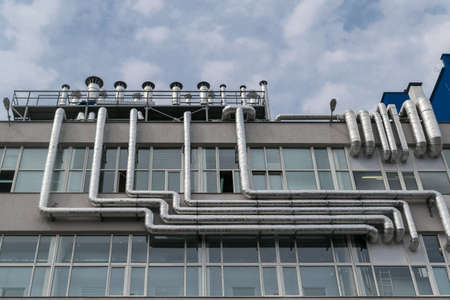 Large number of metal aluminum piping fixed to the facade of the building where a lot of Windows.の写真素材