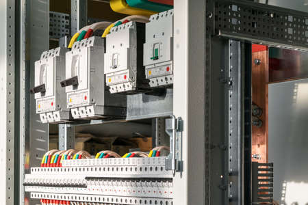 Connecting cables with cable lugs to circuit breakers in the electrical control panel on the...