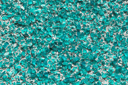 Part of the wall covered with small pieces of glass or quartz sea green. Pieces of glass fixed with...