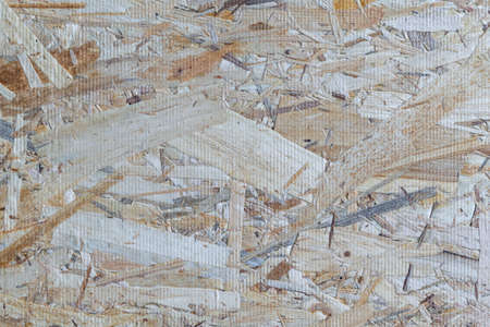 Part of molded plate from sawdust or wood chips. The color of sawdust, chips, yellow, brown, beige, gray. The sawdust fibres arranged randomly.の写真素材