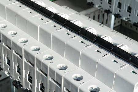 Modular circuit breakers installed in the electrical cabinet. Electrical cabinet assembly production. Installation of electrical equipment on the circuit board.の写真素材