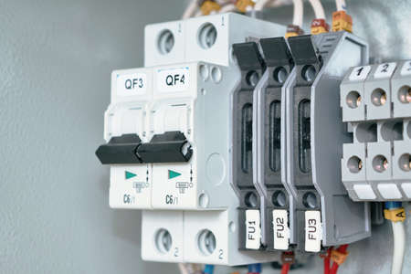 Electrical Cabinet with circuit breakers, terminals with breakers and bushing terminals. To the switches and terminals connected to electric wires marked. Circuit breakers provide reliable protection.の写真素材