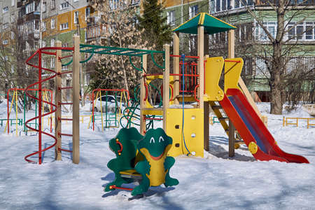A children's Playground with a slide, a ladder, swings, a rope and a frog rocking chair. New play...