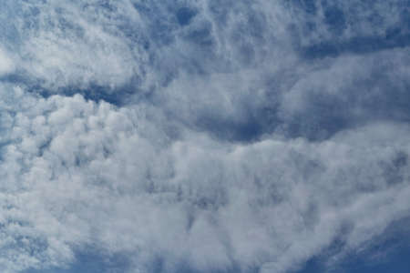 In the pure blue sky, a ragged Cirrus clouds. There are a few small Cumulus clouds. Clouds are...