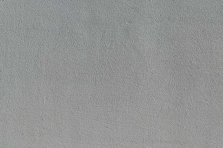 The wall surface is lined with plaster and painted with gray paint. The surface is rough with small pimples and hollows, strips. The wall is homogeneous and rough. Background, backdrop.の写真素材