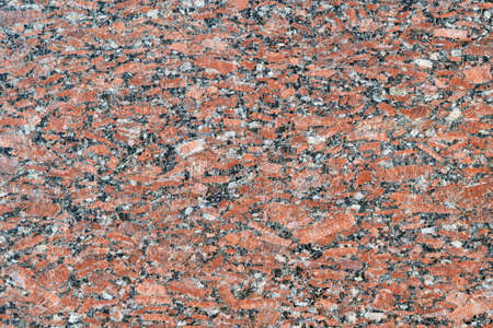 The flat surface of a natural marble or brown granite slab. On the surface there are many small cracks, streaks, stripes and dots. Background, Wallpaper or backdrop. Natural material.の写真素材