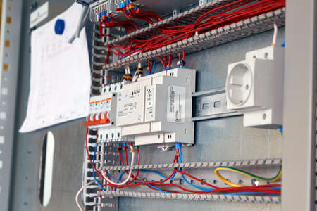 Assembly of the electrical Cabinet according to the scheme. Switches, relays. Connection of electrical wires to the equipment according to the project. Modern, reliable, high-quality production.の写真素材