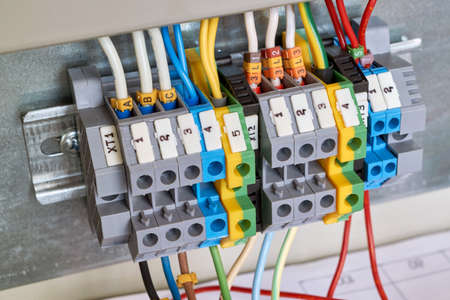 A number of lead-through screw terminals to connect the electrical Cabinet to the mains. The wires are connected, connected with the tips of the scheme or project. Reliability, safety, protection.の写真素材
