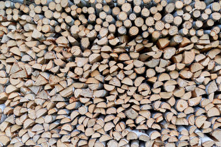Large pile or stock of firewood for heating furnace. Logs and logs of birch. The log is split in half. Slice as a circle or semicircle. Background, backdrop or texture.の写真素材