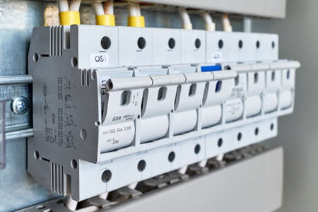 A range of fuse holders or disconnectors in an electrical Cabinet. The holders are fixed on the circuit Board. Small depth of field. Modern, reliable protection of technical and household equipment.の写真素材