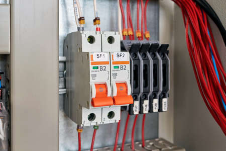 In the electrical Cabinet circuit breakers and fuse holders. Intermediate relay, cable channel for wiring. Modern electrical equipment for the safe distribution of electricity. Technology, production.の写真素材