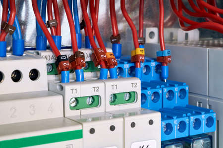 The electrical wires are connected to the intermediate relays and control devices. The cables are marked with numbers. Modern technologies in electrical and technical production.の写真素材