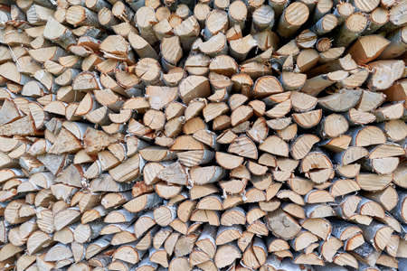 Large pile or stock of firewood for heating furnace. Logs and logs of birch. The log is split in half. Slice as a circle or semicircle. Background, backdrop or texture.の写真素材