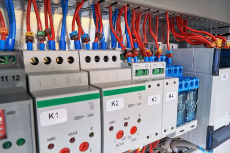 In the electrical Cabinet of the device with adjustment, relay and controller. Wires or cables are connected to the equipment according to the project or scheme. Electricity distribution.の写真素材