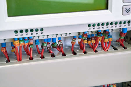 Operator panel or controller with wires connected to it with marking. Electrical cables are connected according to the scheme or project. Modern management and automation in the power industry.の写真素材