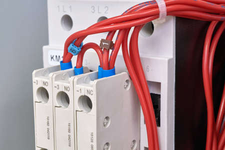 Connection of electrical wires to additional contacts of the magnetic starter. Modern connection of electrical equipment. Distribution of electricity. A bundle of flexible wires.の写真素材