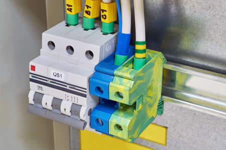 The modular circuit breaker and through terminals are located in the electrical Cabinet. Cables or wires are connected to electrical equipment. Modern, reliable and safe industrial equipment.の写真素材