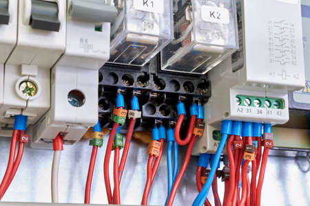 Intermediate electrical relays, circuit breakers in electrical Cabinet. Flexible wires and cables are connected to electrical equipment according to the scheme or project.の写真素材