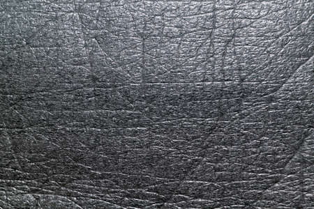 Surface of the soft porous packaging film or dark gray material. Film gray. Texture with vertical, horizontal and diagonal lines at the bend points. Background, backdrop. Modern packaging material.の写真素材