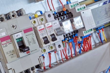 Industrial and modular circuit breakers, intermediate relays, device and surge protector in electrical Cabinet. Professional Assembly of electrical cabinets according to the scheme or project.の写真素材