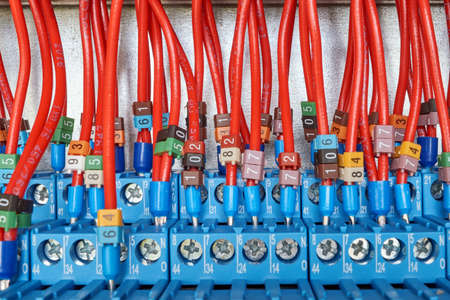 Many electrical wires are connected to intermediate relays. Wires and cables are marked with numbers. Relays switch electrical equipment automatically according to the scheme, project.の写真素材