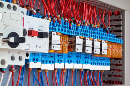 Motor protection circuit breakers and intermediate relays in electrical Cabinet. The wires are connected to the electrical equipment according to the scheme. Automatic control and distribution.の写真素材