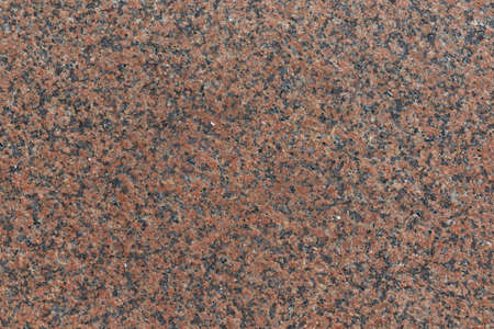 The flat surface of the granite slab is brown in speckled with black spots. Granite consists of crystals of stones of brown, red, black, gray color. Background, backdrop, texture.の写真素材