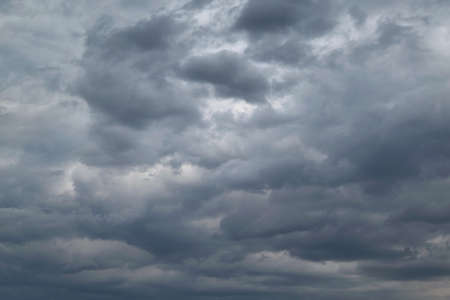 Bad weather. Strong wind and feeling the rain. The clouds are dark blue.の写真素材